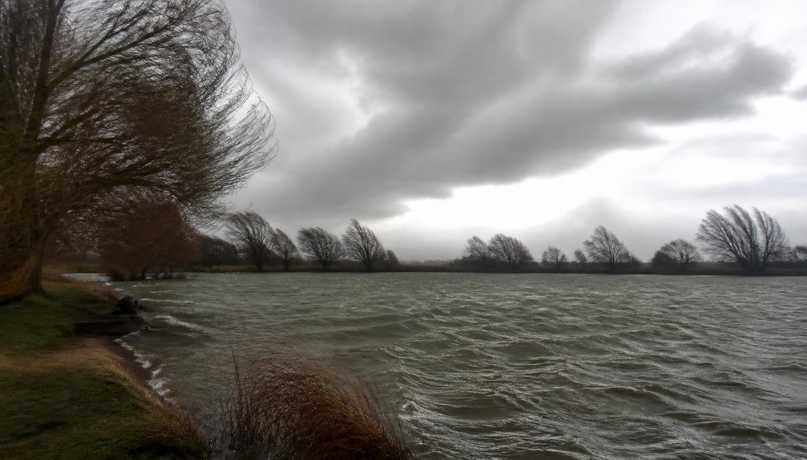 A hard wind pushing into the windward bank as a front rolls through.